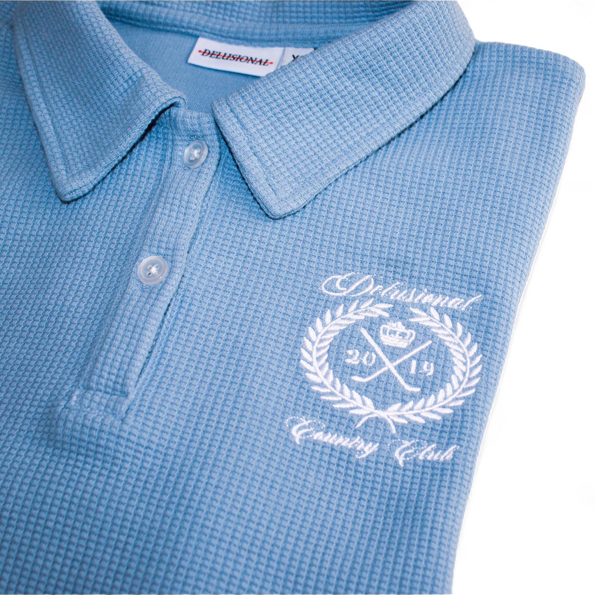 Embroidered artwork detail on women's cotton waffle polo