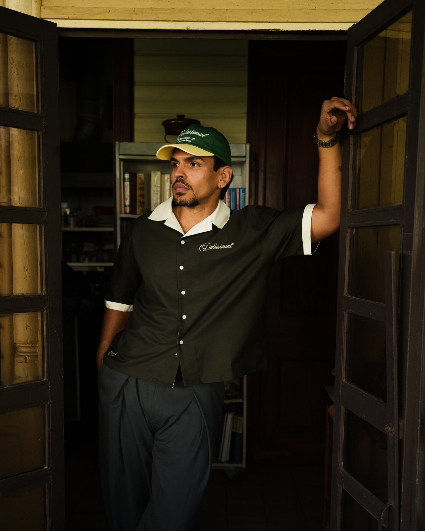 Model wearing Designed in PR button-up shirt in Puerto Rico in doorway