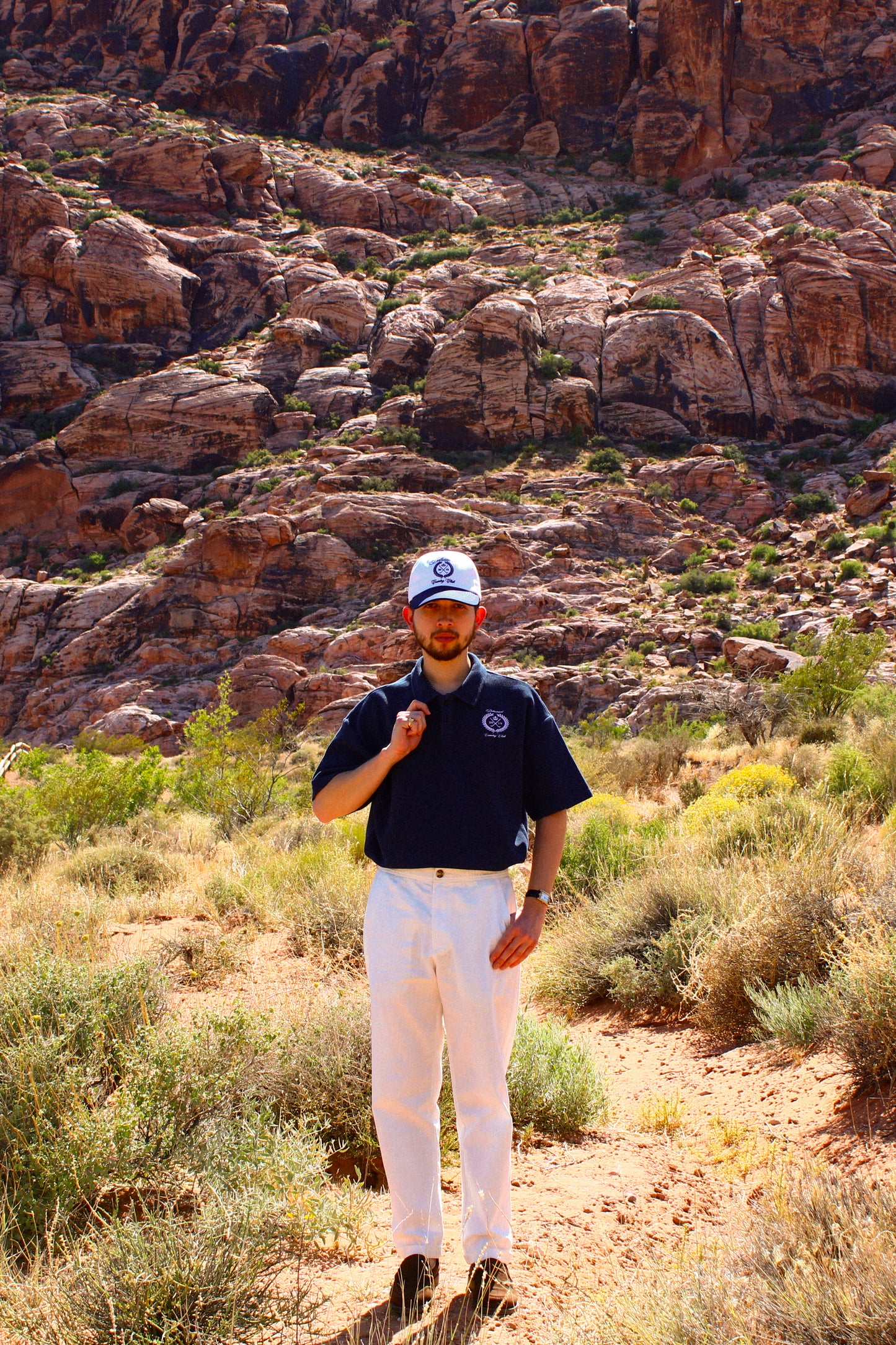Model wearing Country Club polo by Delusional