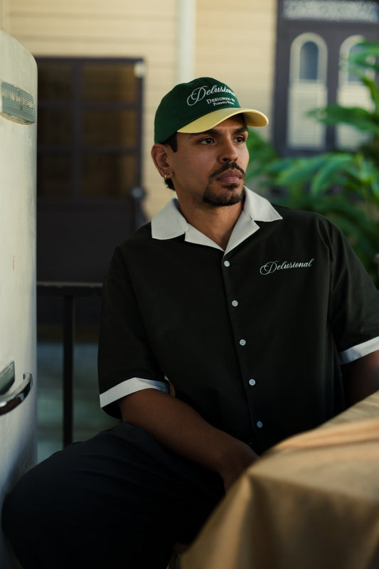 Model wearing Designed in PR two-tone cap by Delusional